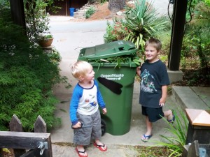 Leaf-eating monster robot composting cart and kids.